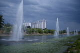 View of the Rusanovka canal, fountains working, buildings on the background and cloudy sky. Kiev, Ukraine