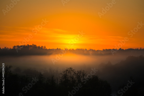 A misty sunrise landscape over the small river valley. Summertime scenery of Northern Europe.