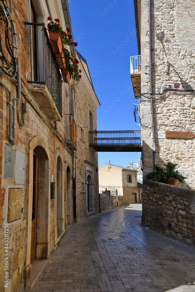 A narrow street between the old houses of Sant'Agata di Puglia, a medieval village in southern Italy.