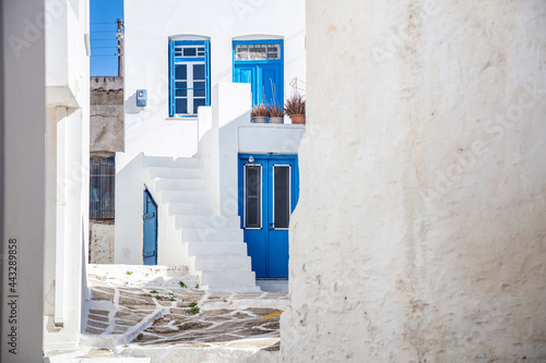 Fototapeta Naklejka Na Ścianę i Meble -  Kythnos island, Greece. Traditional whitewashed buildings and stairs, blue doors and windows, narrow streets