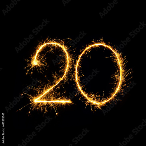 Sparkling number 20 isolated on black background photo