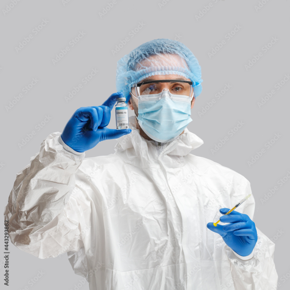 A man in a protective antibacterial suit. The concept of anti-epidemic measures. A warning sign. AntiCOVID. Vaccine against coronavirus A man in a protective antibacterial suit. The concept of anti-epidemic measures. A warning sign. AntiCOVID. Vaccine against coronavirus
