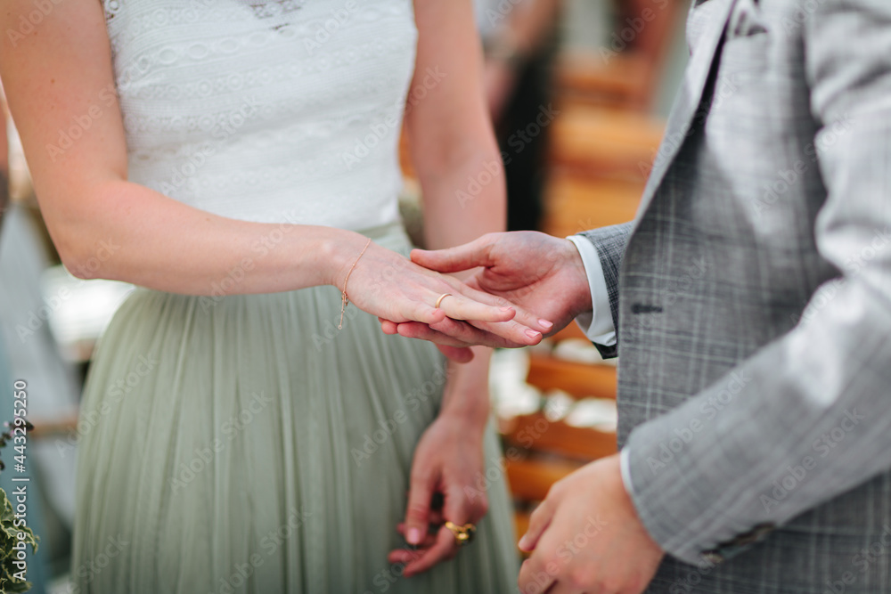 Bride and groom exchanging rings at their wedding close up.
