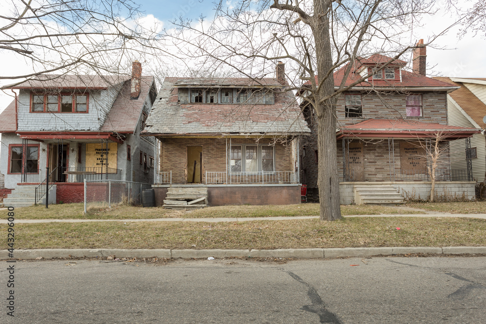 Street of abandoned houses in urban Detroit on cloudy day Street of abandoned houses in urban Detroit on cloudy day