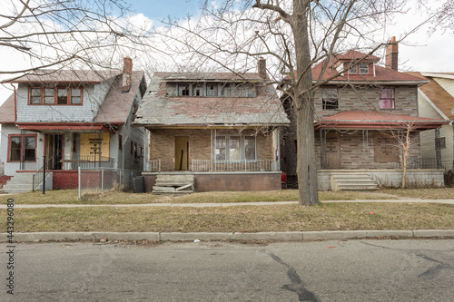 Street of abandoned houses in urban Detroit on cloudy day