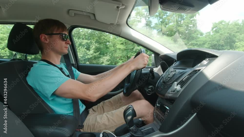 Man driving on highway slow motion car sunny day Man driving on highway slow motion car sunny day