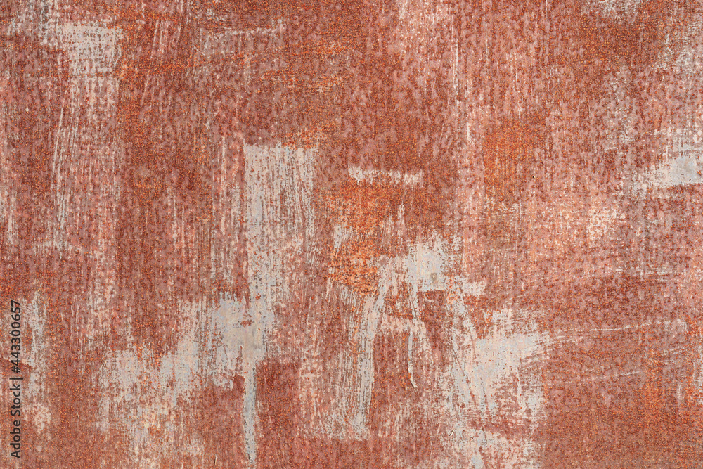 Fototapeta premium Fragment of a steel sheet covered with red-brown paint. There are irregular gray strokes. Rust points appear everywhere. Background. Texture.