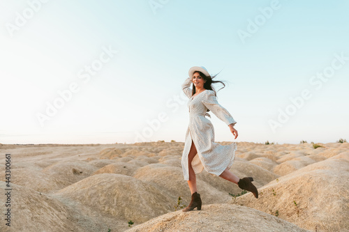 Young beautiful girl on the sand dunes at dawn