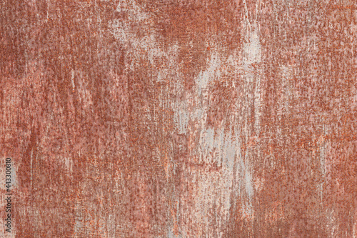 Fragment of a steel sheet, red-brown color. Gray paint strokes are available. There are multiple points of corrosion, rust. Background. Texture.