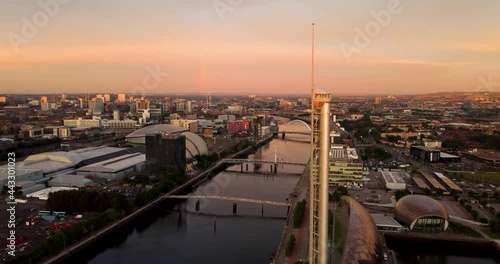 Aerial drone view, along the River Clyde, in Glasgow skyline at sunset. Views over city and landmarks. 4k