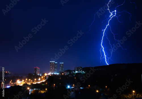 Thunderstorm over the city in blue light. Lightning in the night city  Russia  Yekaterinburg.