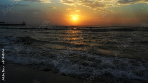 The colorful sunset ocean beach with deep chlorine sky and sun rays. 