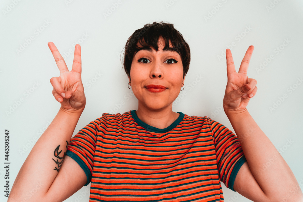 Happy woman looking the camera with peace sign Happy woman looking the camera with peace sign