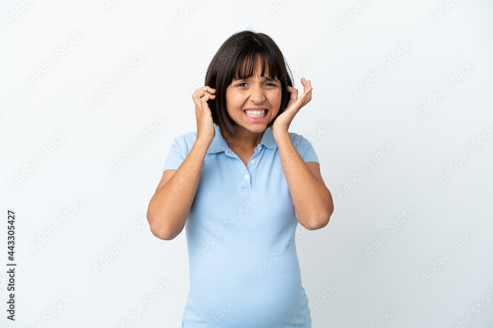 Pregnant woman over isolated white background frustrated and covering ears Pregnant woman over isolated white background frustrated and covering ears