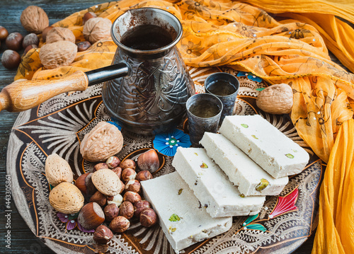 Greek halva, nuts and greek coffee on a colorful tray.