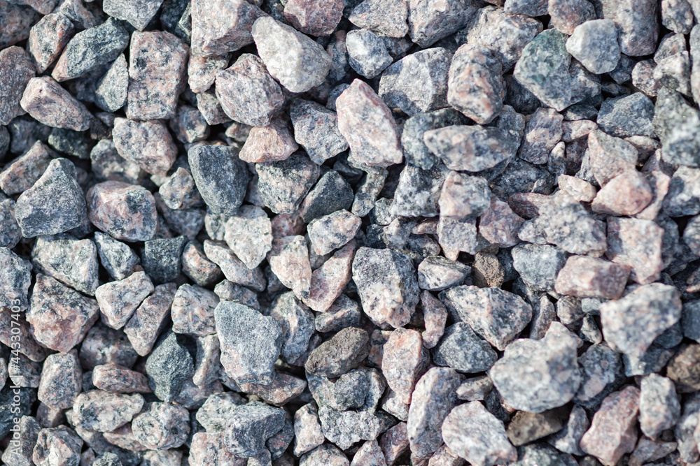 The texture of light gray granite gravel, used as a background The texture of light gray granite gravel, used as a background