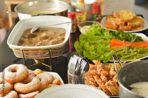 Western Food Dish Background with garlic bread, donuts, vegetables, french fries, slices fried chicken and slices beef steak