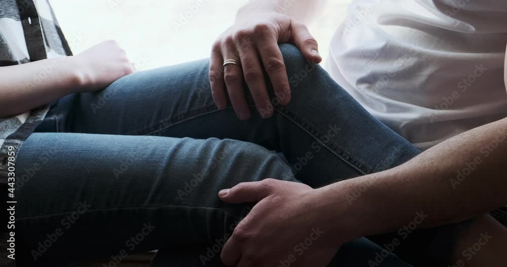 Young couple man and woman sitting on window sill and enjoying old town view. Happy young lovers enjoy time spending together at home Young couple man and woman sitting on window sill and enjoying old town view. Happy young lovers enjoy time spending together at home
