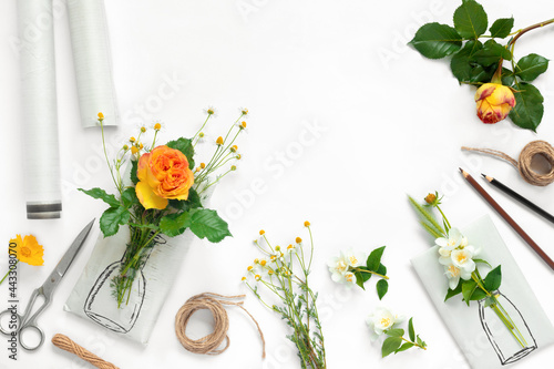 Set of wrapping paper and flowers for handmade on on white background. Homemade craft box gifts with painted vase, bouquet of yellow roses and delicate daisies.