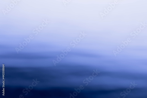 Abstract shot of blurred sea water surface with skyline. Background