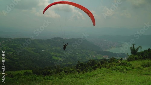 paraglider in the mountains over a lake