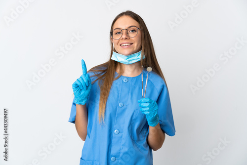 Lithuanian woman dentist holding tools over isolated background showing and lifting a finger in sign of the best