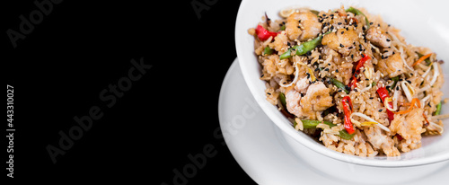 Panoramic view of oriental rice dish on black background