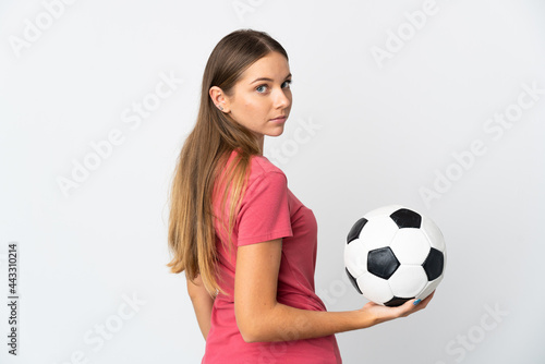 Young Lithuanian woman isolated on white background with soccer ball © luismolinero