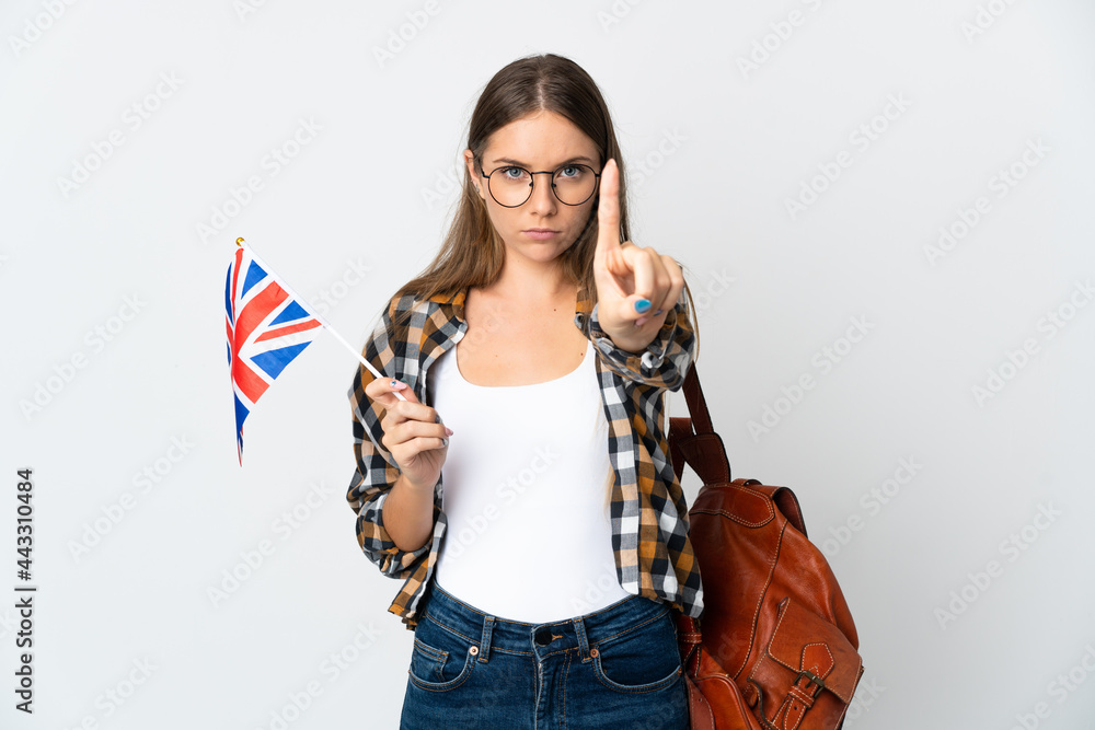 Young Lithuanian woman holding an United Kingdom flag isolated on white background counting one with serious expression Young Lithuanian woman holding an United Kingdom flag isolated on white background counting one with serious expression