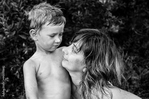 A mother with her young son after swimming. Black and white photo.