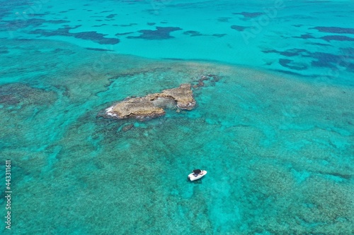 Aerial view of boats anchored near coral rocks off North Bimini  Bahamas on sunny summer afternoon.