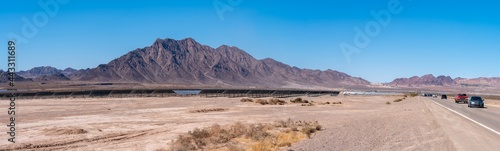 Photography Panoramic View of Highway With Large Solar Farm on the Side of the Road and Larg