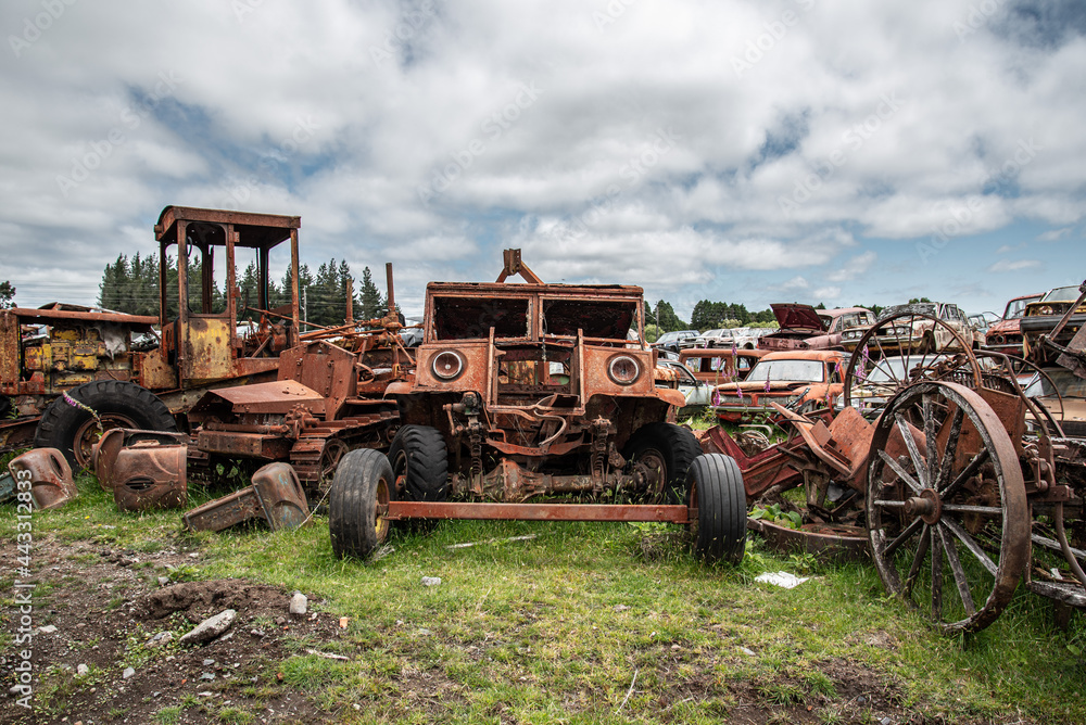 Antique cars on a big scrapyard at the end of Old Coach Road Trail, New Zealand