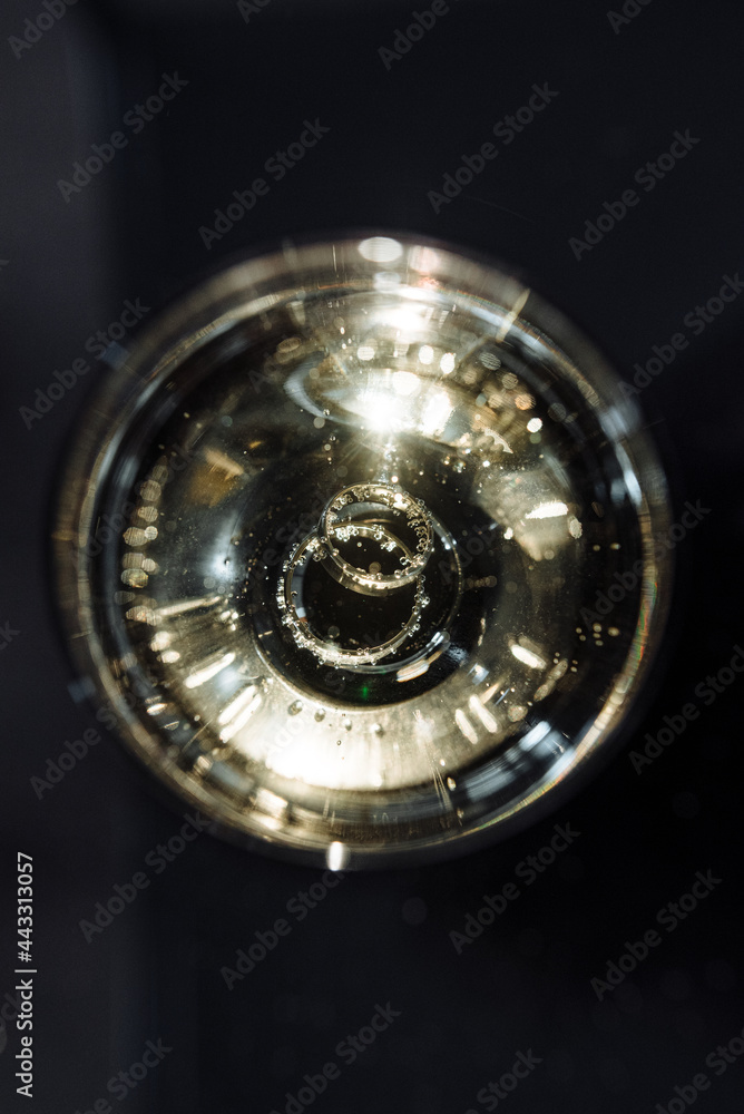 Wedding rings in a glass of champagne Wedding rings in a glass of champagne