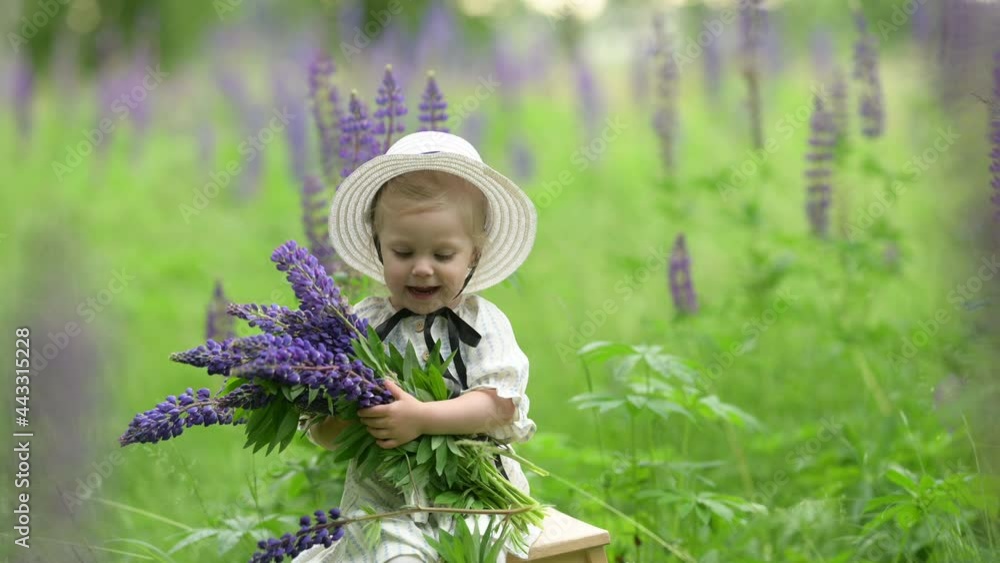 Happy child in the park. Cute little girl in a hat with a bouquet of wildflowers in a spring park. children, emotions. Happy child in the park. Cute little girl in a hat with a bouquet of wildflowers in a spring park. children, emotions.