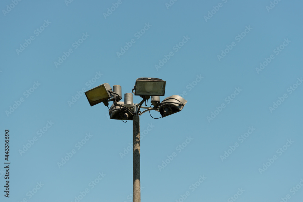 sports field spotlights on a blue sky - daytime sports field spotlights on a blue sky - daytime