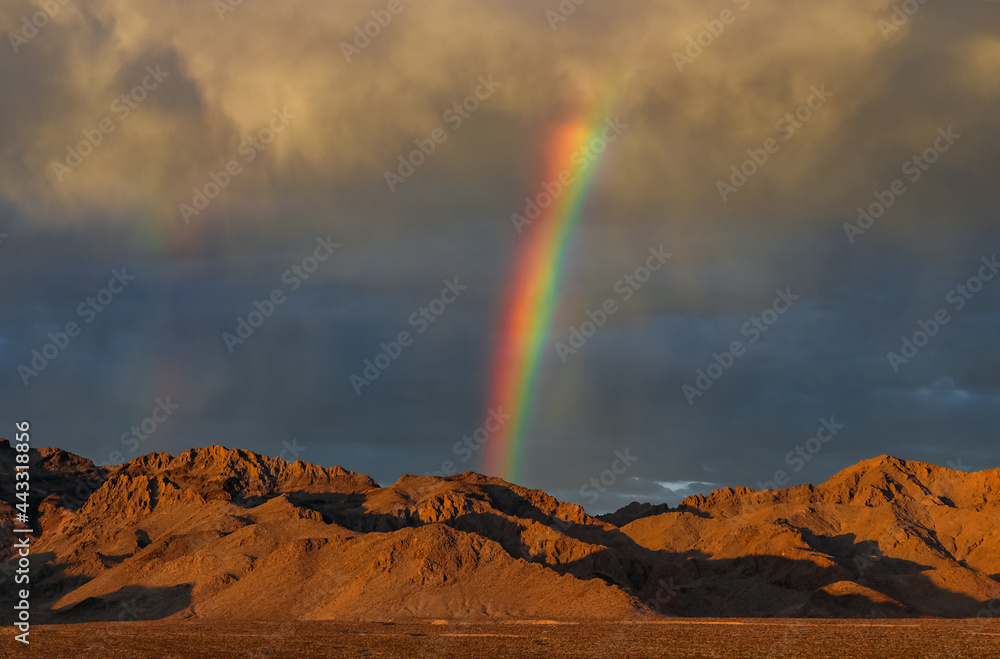 A stunning rainbow over the horizon in the desert of Nevada. 