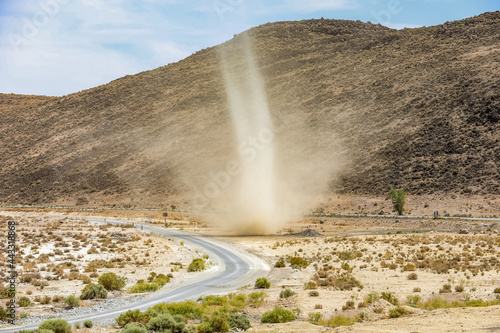 A large dust devil in the middle of the desert.