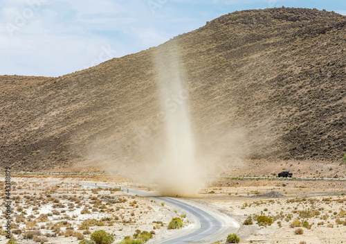 A large dust devil in the middle of the desert.