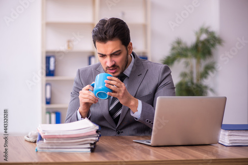Young businessman employee having break at workplace