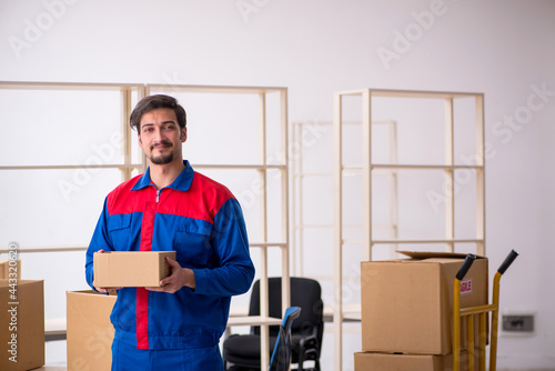 Young male contractor in movement concept at workplace