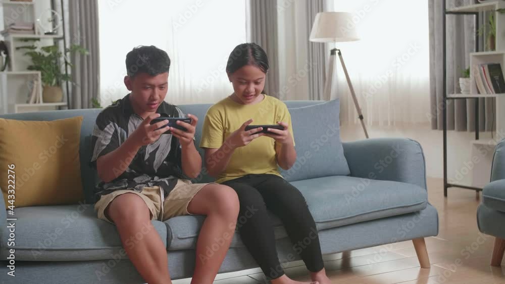 Asian Children Playing Video Games On Mobile Phone And Disappointed At Home
Asian Children Playing Video Games On Mobile Phone And Disappointed At Home