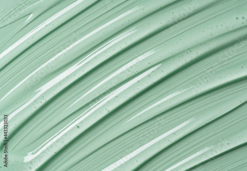 Serum texture on transparent liquid gel background with green background.
