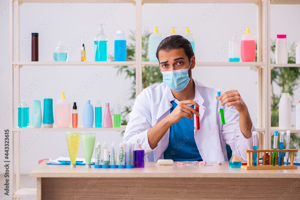Young male chemist testing soap in the lab Young male chemist testing soap in the lab