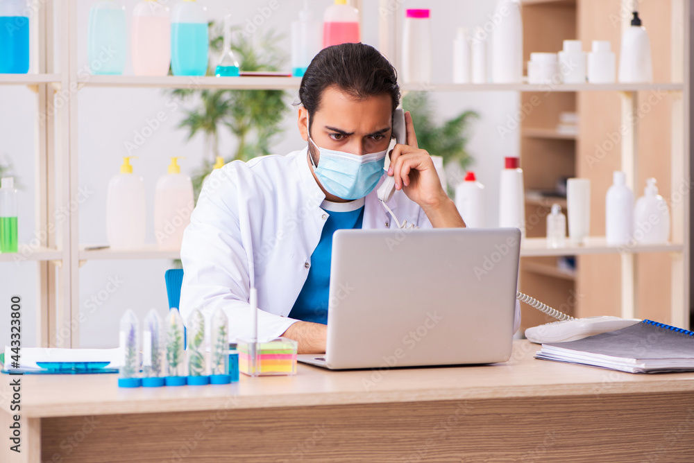 Young male chemist testing soap in the lab Young male chemist testing soap in the lab