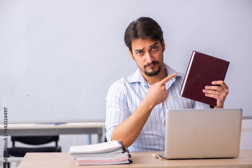 Young male teacher in front of whiteboard Young male teacher in front of whiteboard