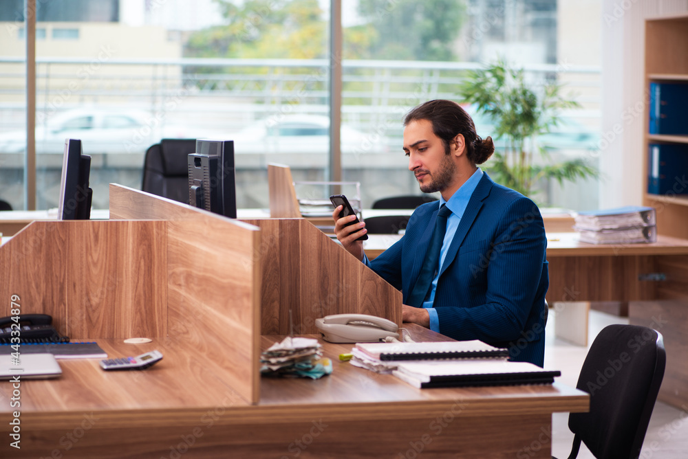 Young male employee working in the office Young male employee working in the office