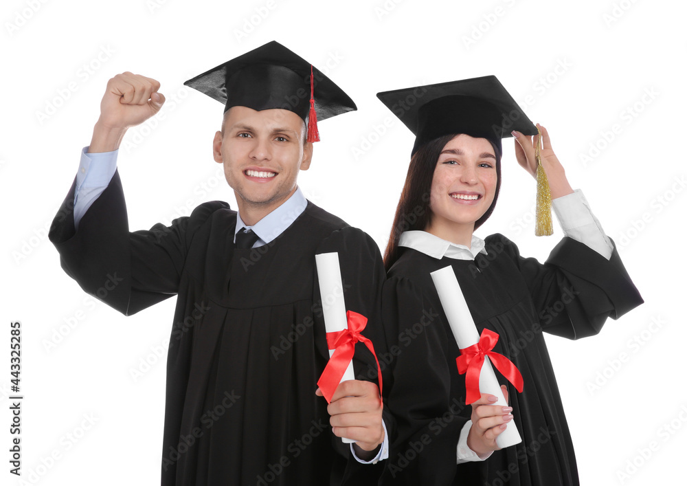 Happy students in academic dresses with diplomas on white background Happy students in academic dresses with diplomas on white background