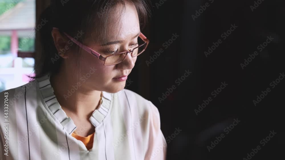 A woman working at home in the dark A woman working at home in the dark