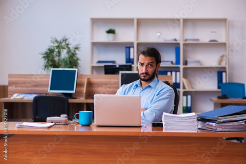 Young male employee working in the office © Elnur